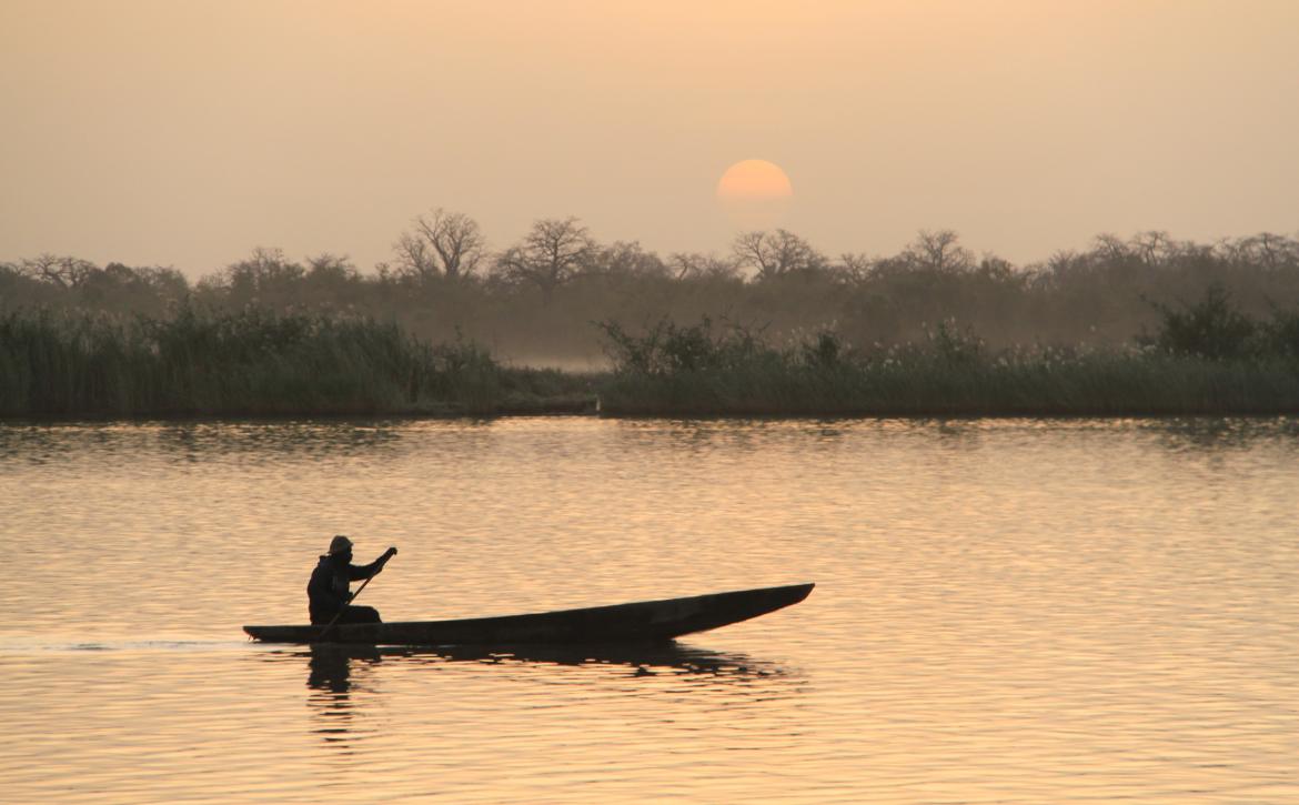 Traditional boat sailing with sunset in the background