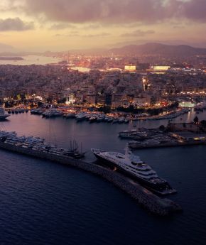 A view of a port and a town during sunset