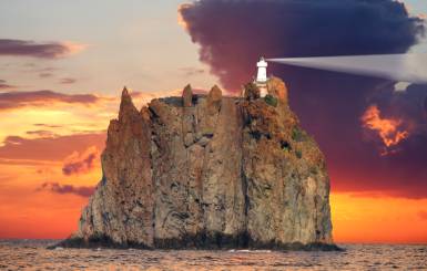 A lighthouse on the rocky Stromboli Island overlooking the Mediterranean