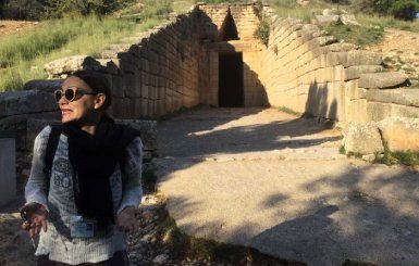 A photo of a tourist in front of ancient tomp of Atreas