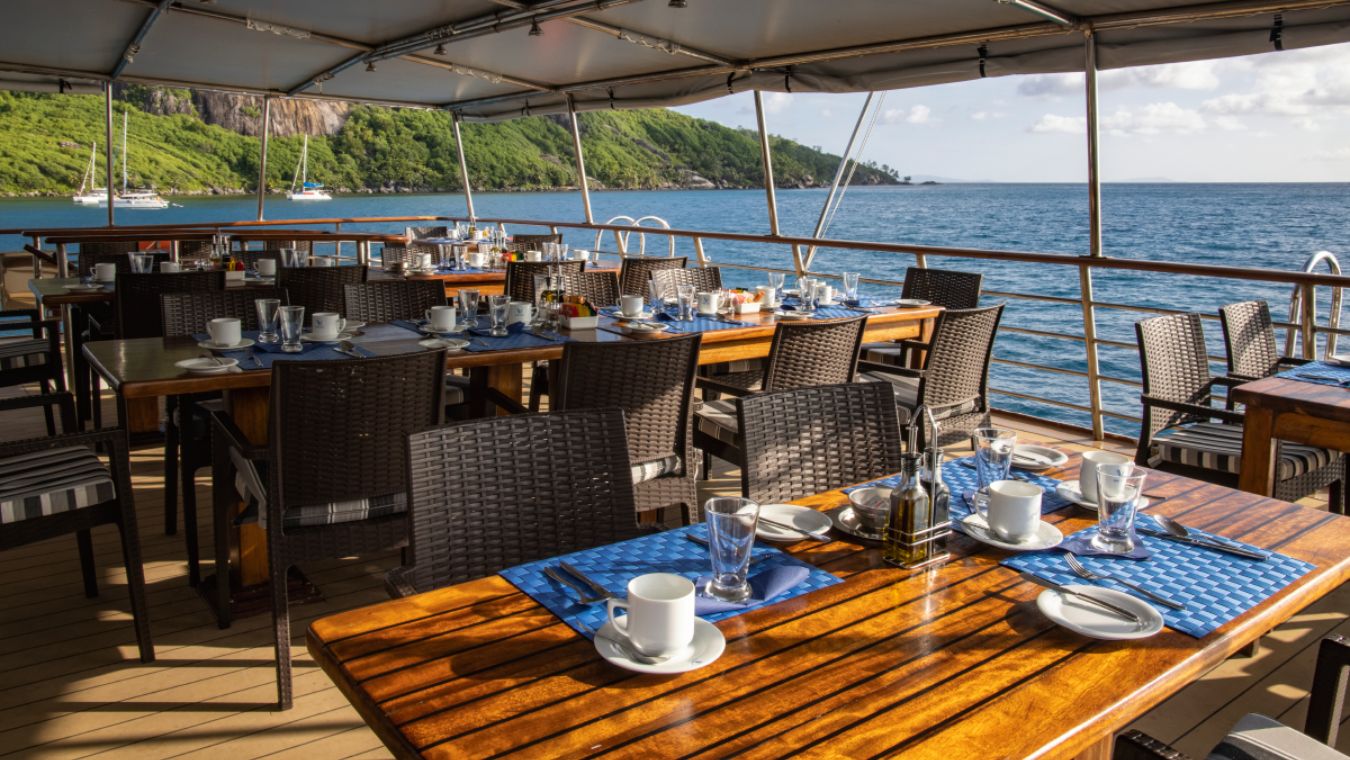 Dining area on deck of a small boat of Variety Cruises
