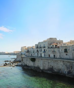 A beautiful view of the coastline of Syracuse with traditional buildings