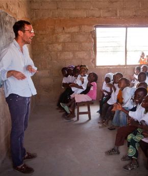 A teacher in a class room with kids in Africa