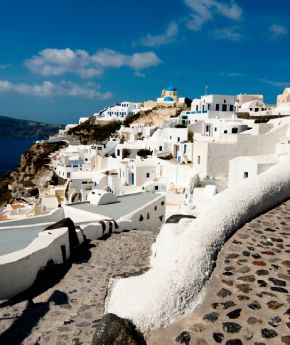 The picturesque village of Oia in Santorini, Greece, with its iconic white houses and blue domes