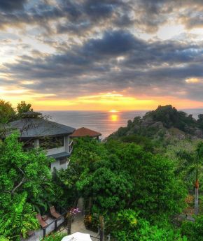 View from a tropical forest to the sea during sunset