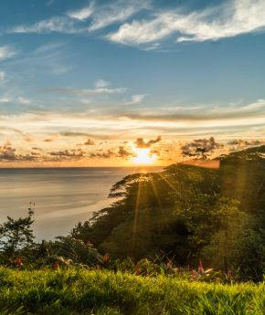 View of to a tropical island with the sunset in the background