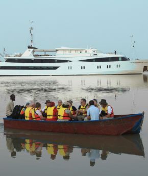 trourist trasfered in local boat with a Variety Cruises' ship in the background