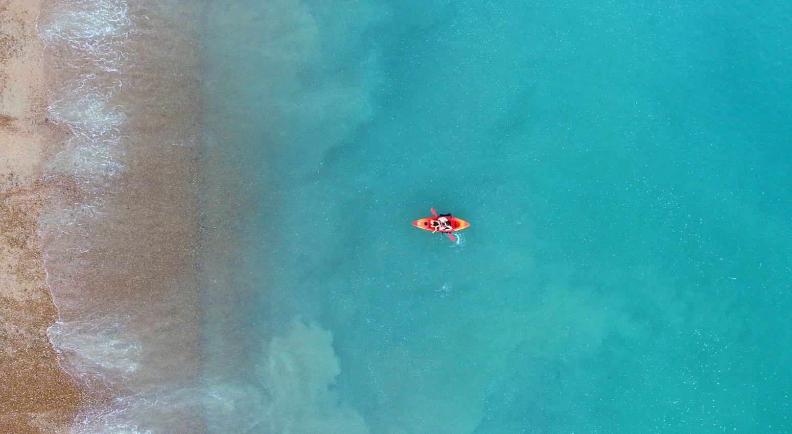 Guests Kayaking in turquoise waters during a Variety Cruises Expedition