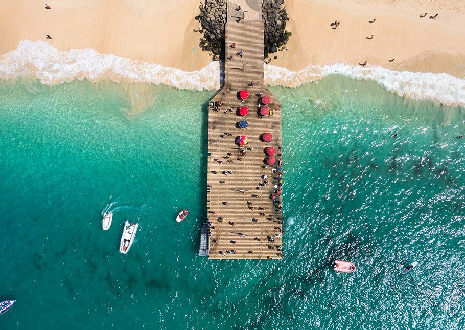 Aerial view of small ships anchored in a tropical beach with turquoise waters