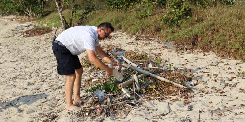 A man cleaning the beach