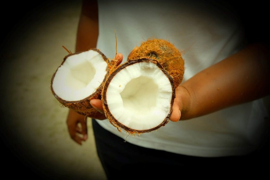 A man holding coconuts