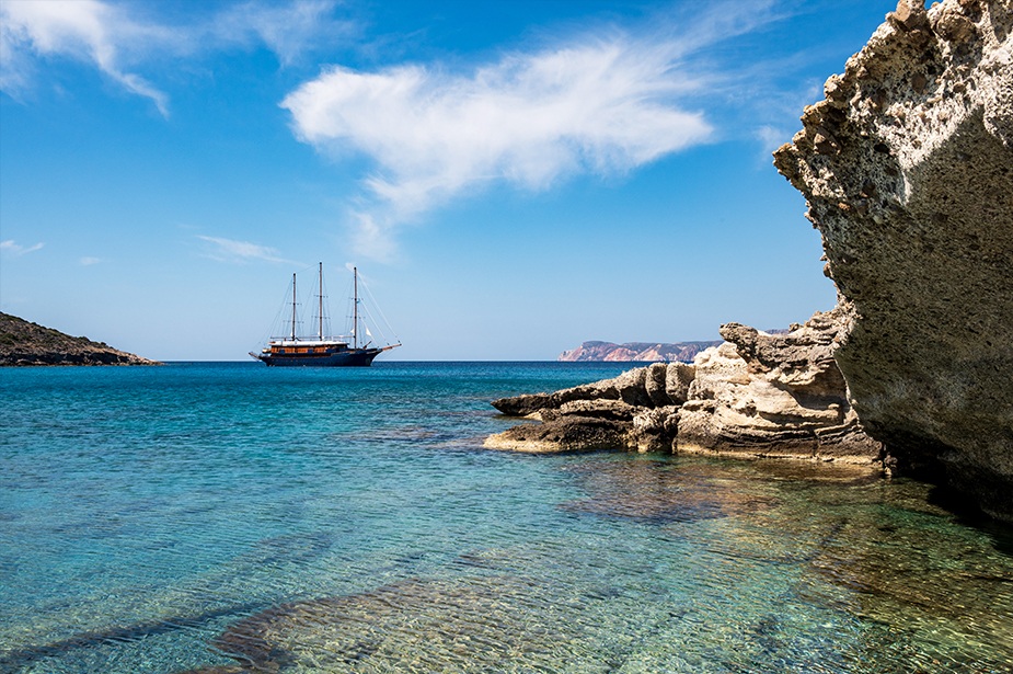 Galileo ship sailing between rocky islands