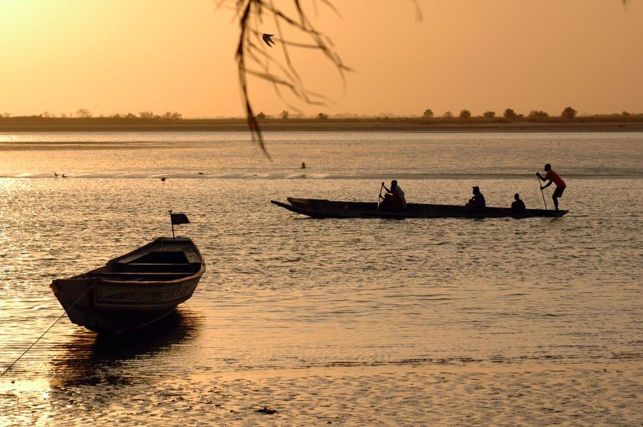 Traditional fishing boats with sunsent in the background