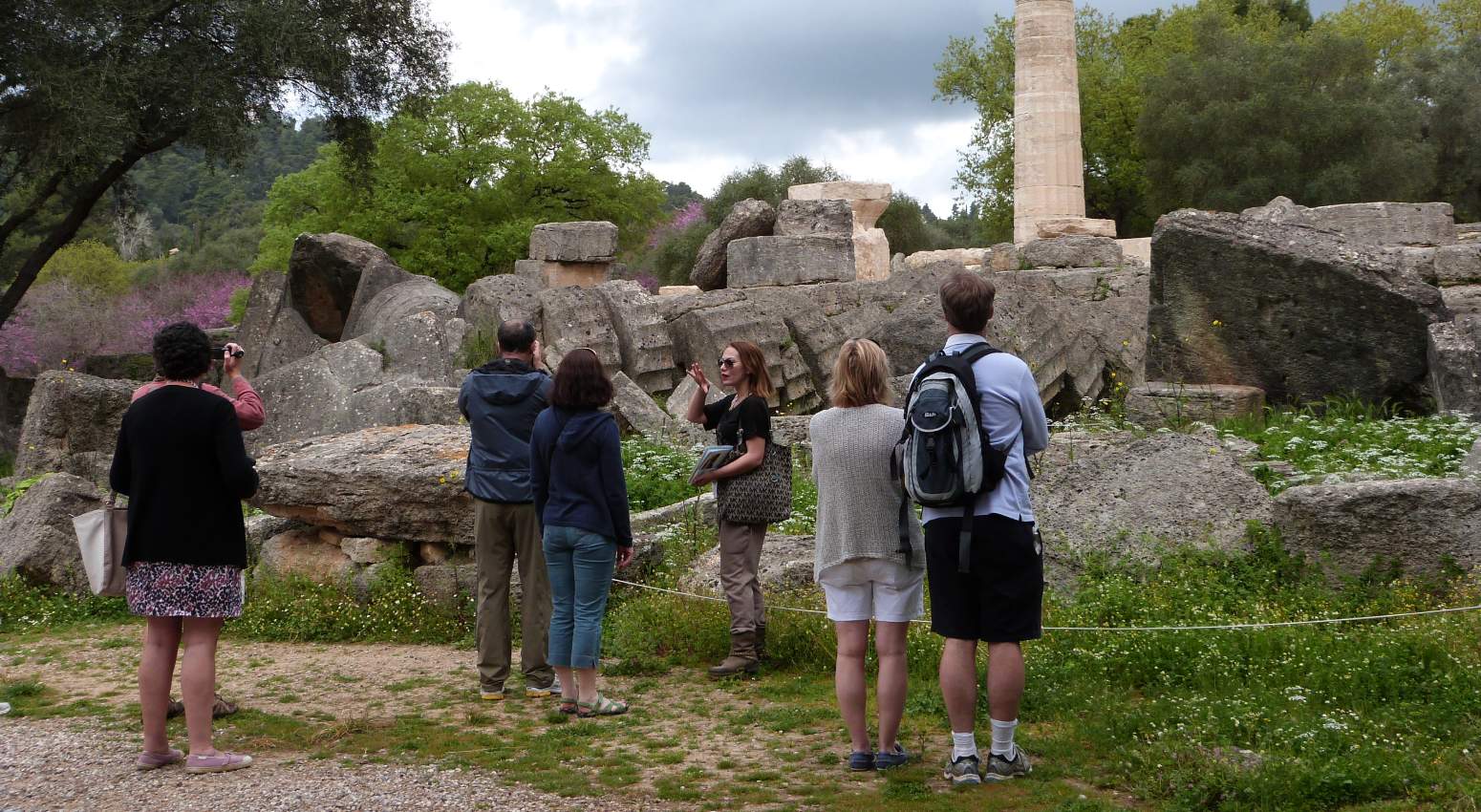 A guide giving a tour of an ancient site to a group of tourists on a Variety Cruises excursion