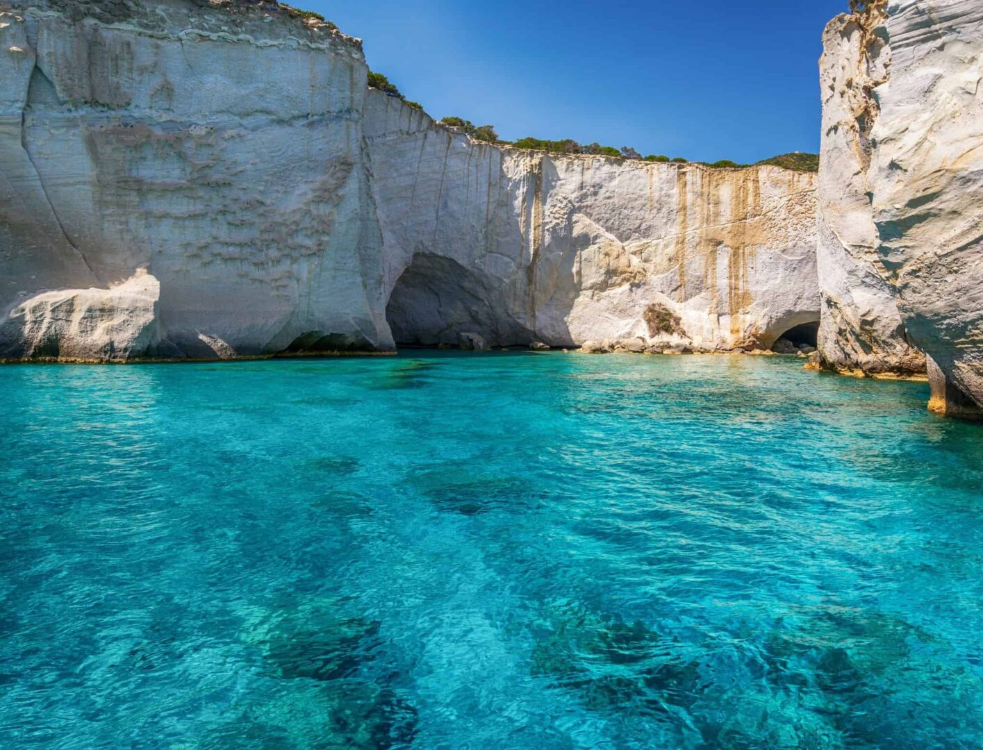 Turquoise waters and white sharp clifs in Kleftiko beack of Milos island, Greece