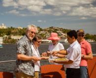 A group of tourists tasting the local cuisine on board