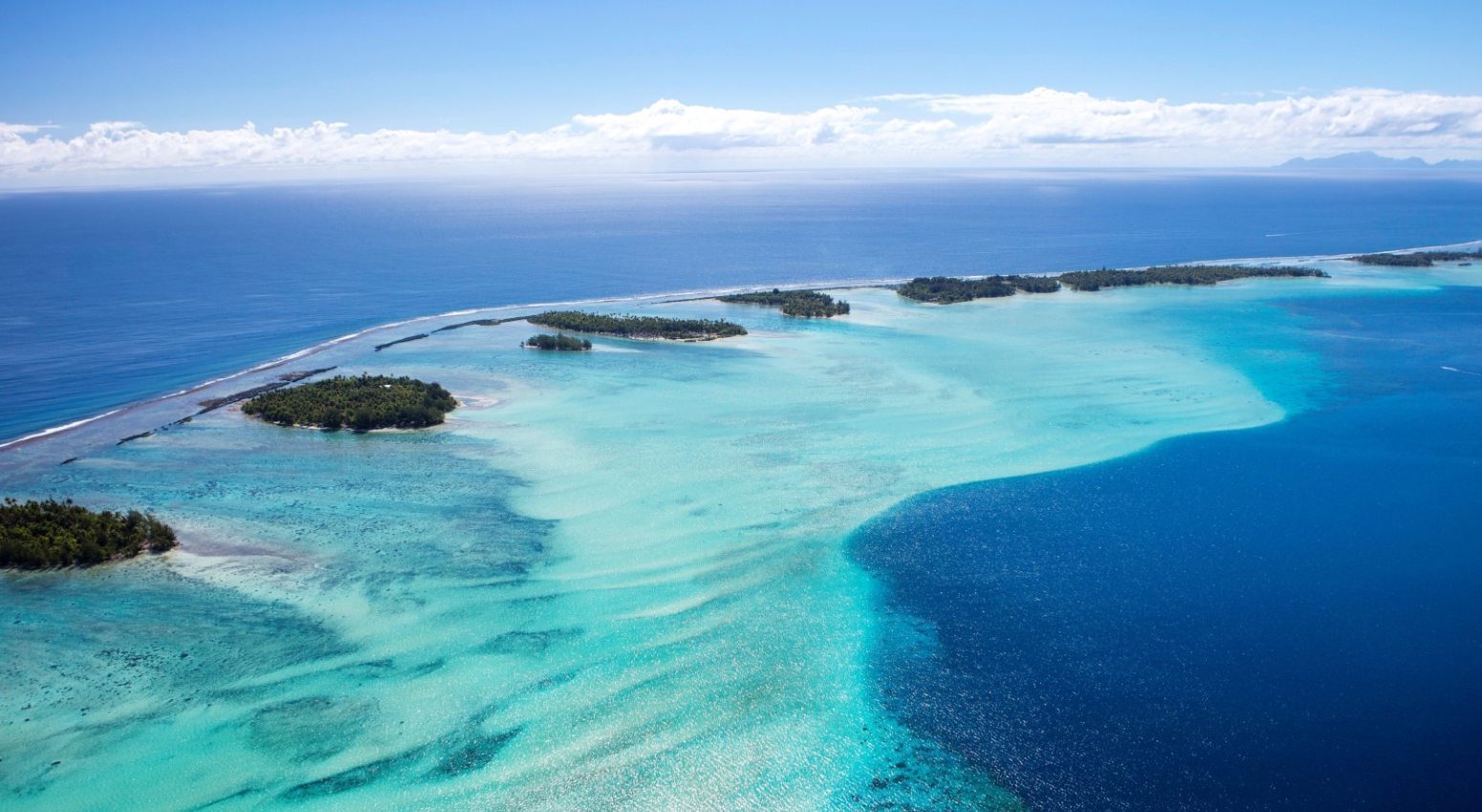 Scenic view of Bora Bora's turquoise waters from a helicopter