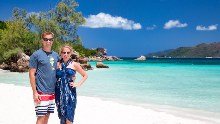 A couple enjoying the beach and turquoise waters of Seychelles