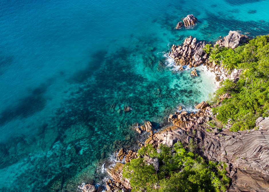 View to turquoise waters and rocky beach of Seychelles