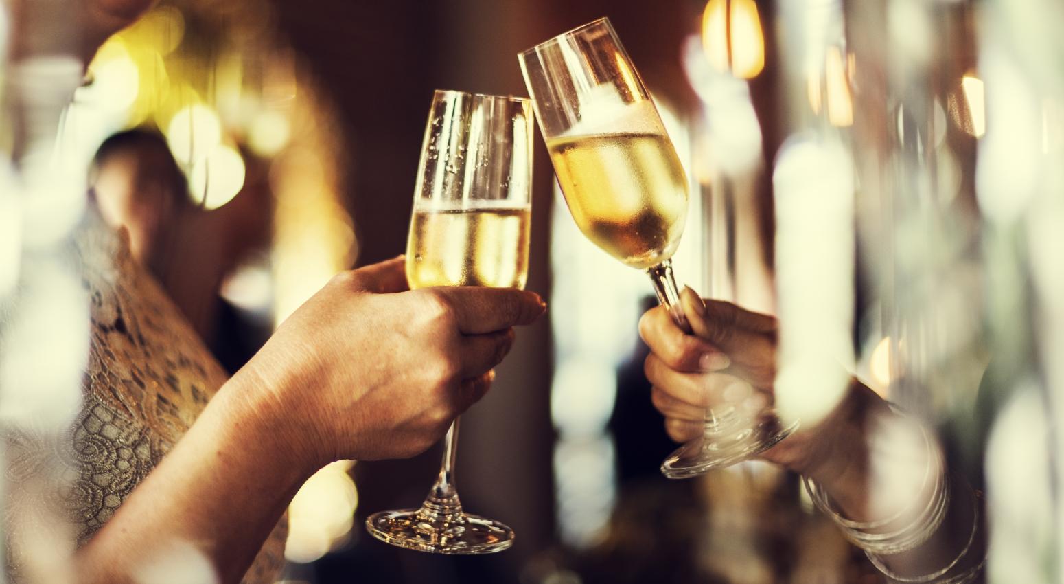 two people toasting with glasses of champagne