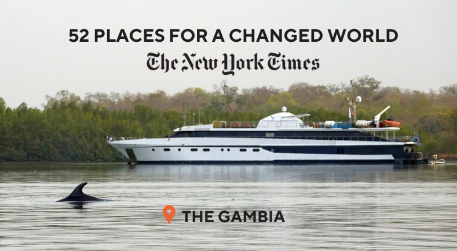 A sharp in the water with a Variety Cruises' ship in the background in Gambia, one of the 52 places for a changed world according to New York Times