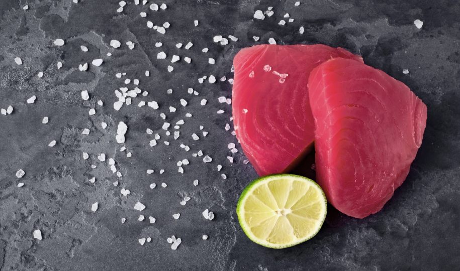 Close-up of a plate of seared tuna with lime and vegetables