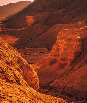 A view of Wadi Rum desert with rock formations in the background