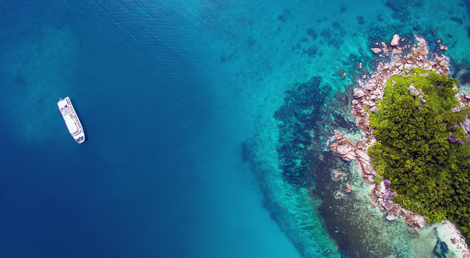 Aerial view of Variety Cruises small ship sailing in blue waters in Cape Verde