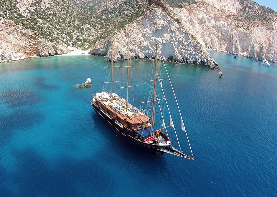 Variety Cruises boat sailing close to rocky beach