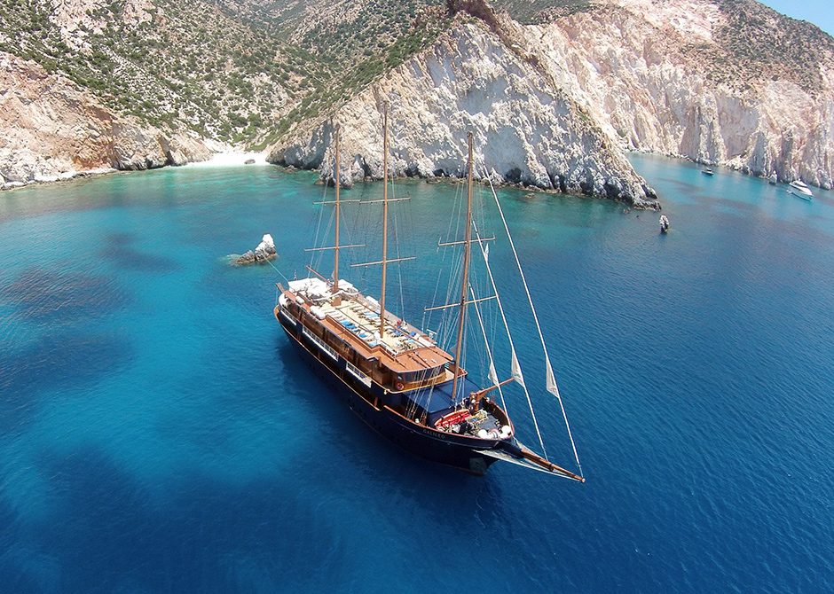 Variety Cruises boat sailing close to rocky beach