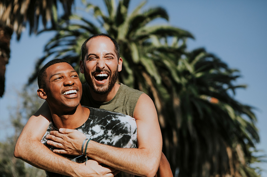 Two men hugging and smiling