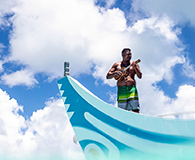 Local man playing a music instrument on a boat