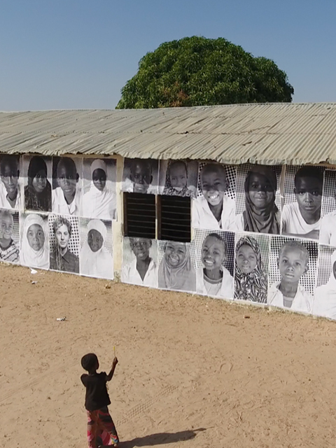 A school at lamin koto with a kid in the yard