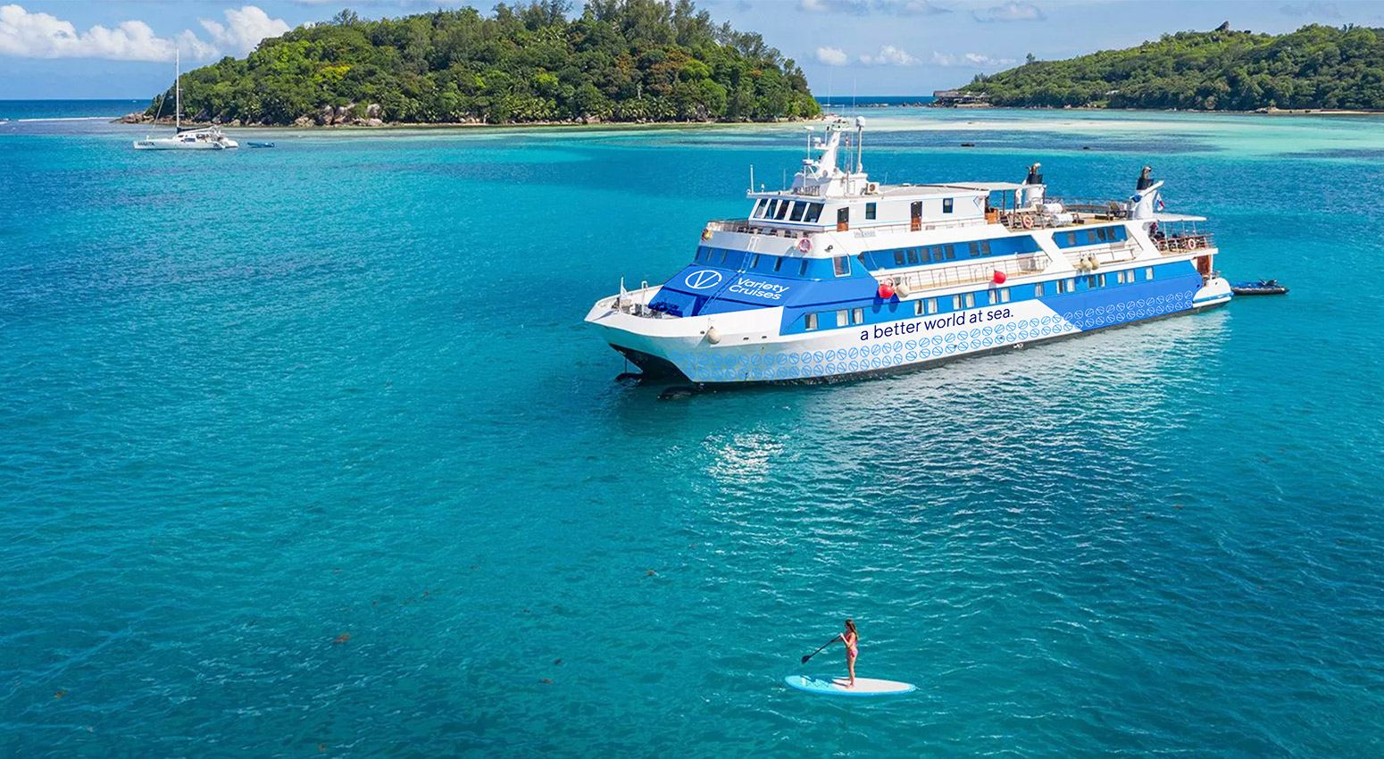 A variety cruises ship with tropical islands on the background