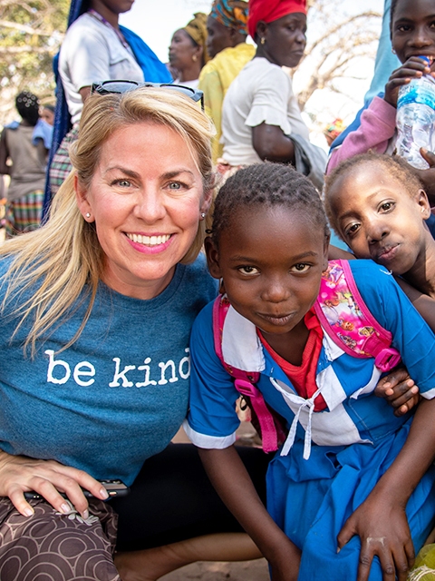 A Variety Cruises member with local kids in Africa