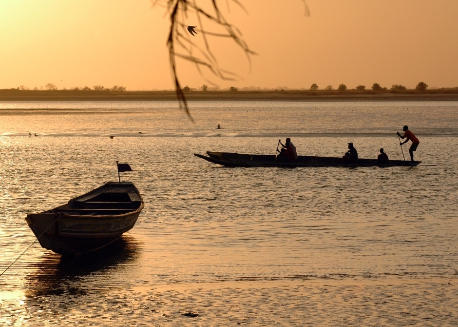 Traditional boats in West Africa during sunset